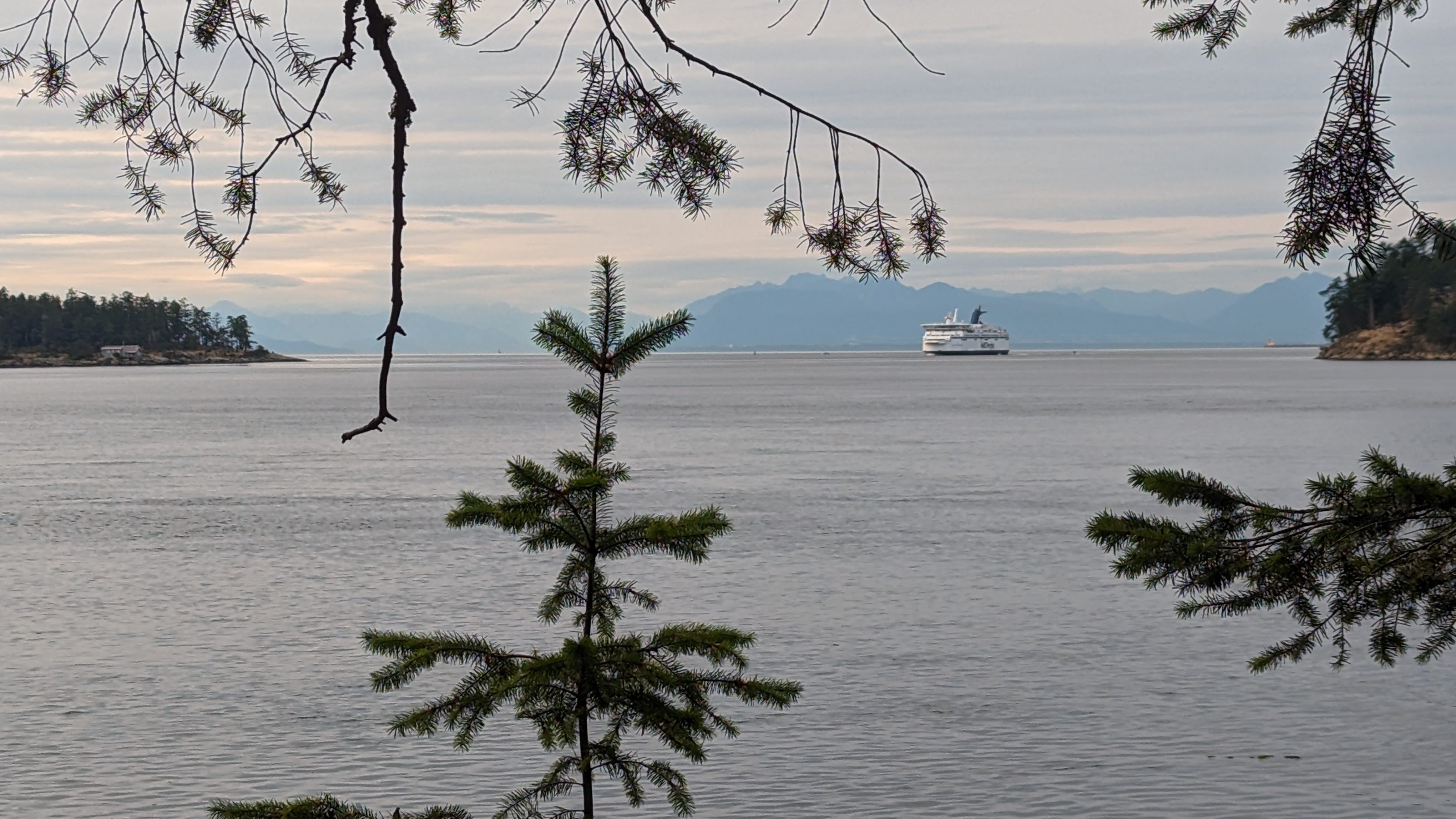 A ferry sailing by an island