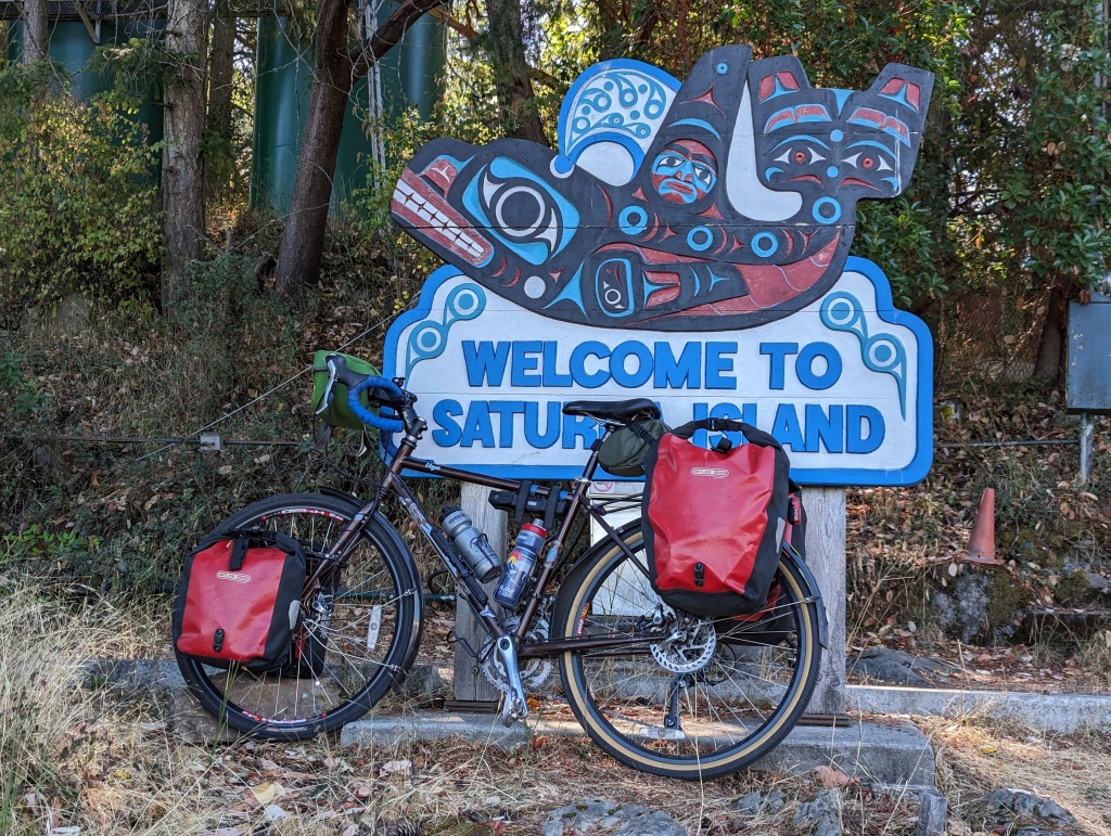 A bike leaning against a sign